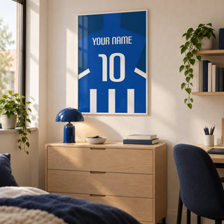 Football Shirt Poster in Blue and White Stripes with White Number, framed on the wall of a tidy university room for a football fan (18-21) with a warm white wall and simple birch furniture in a home office