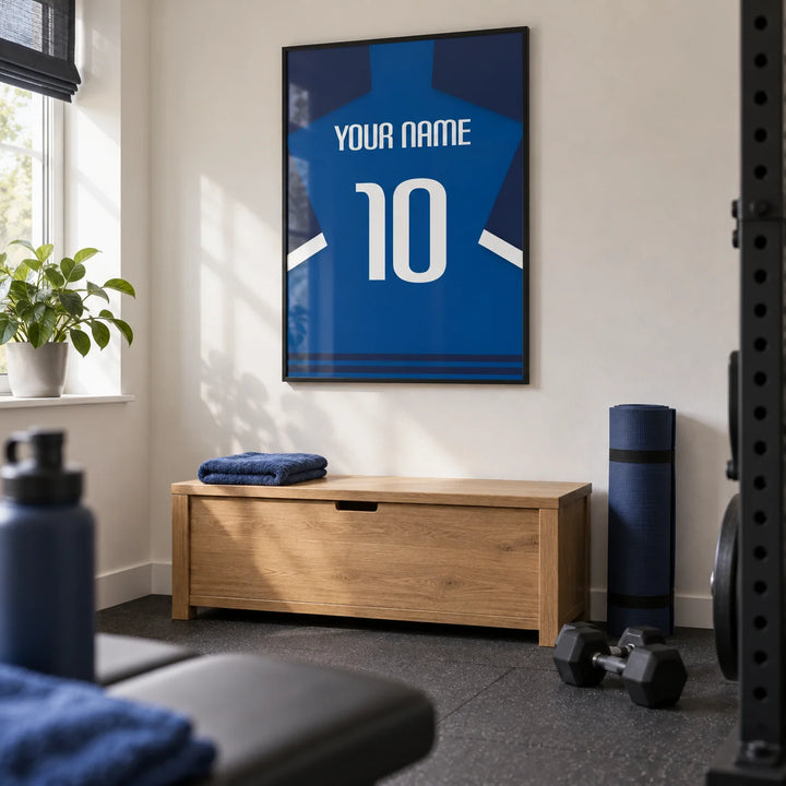 Football Shirt Poster in Blue with Dark Sleeves and White Stripe, framed on the wall of a compact home gym in a converted UK spare room