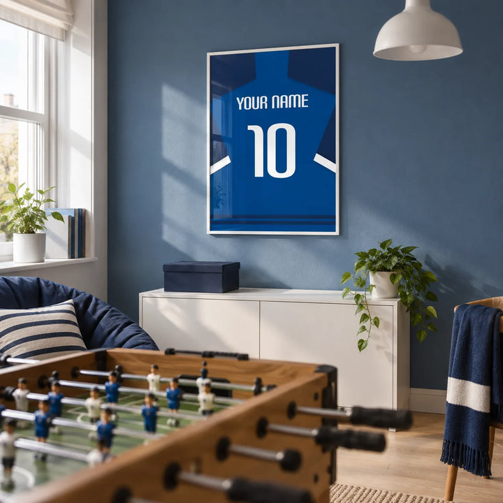 Football Shirt Poster in Blue with Dark Sleeves and White Stripe, framed on the wall of a football fan's small games den in a UK family home