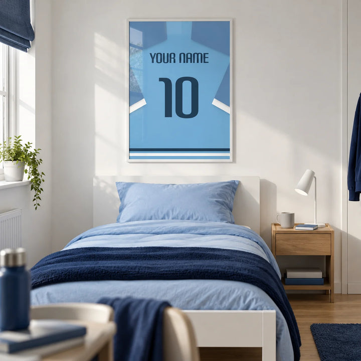 Football Shirt Poster in Light Blue with Dark Blue Number, framed on the wall of a modern football-loving teenager's single bedroom (13-17) in a UK family home with a white wall and oak floor