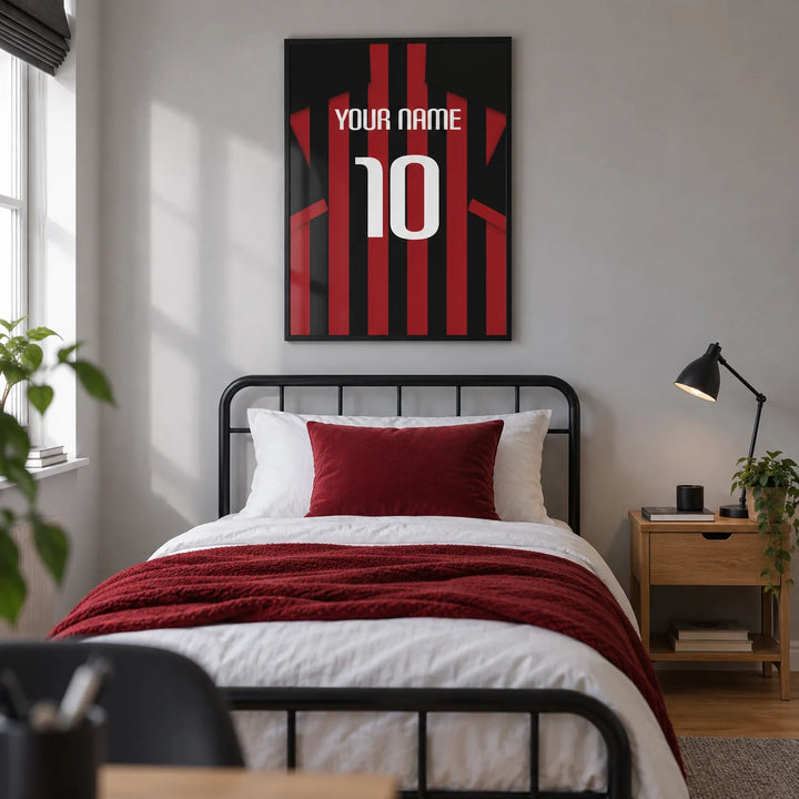 Football Shirt Poster in Red and Black Stripes, framed on the wall of a modern football-loving teen's single bedroom (13-17) in a UK family home with a pale grey wall and oak floor