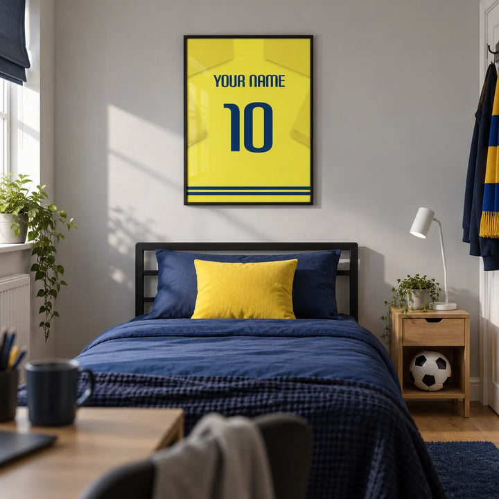 Football Shirt Poster in Yellow with Blue Number, framed on the wall of a modern football-loving teenager's single bedroom (13-17) in a UK family home with a pale grey wall and oak floor