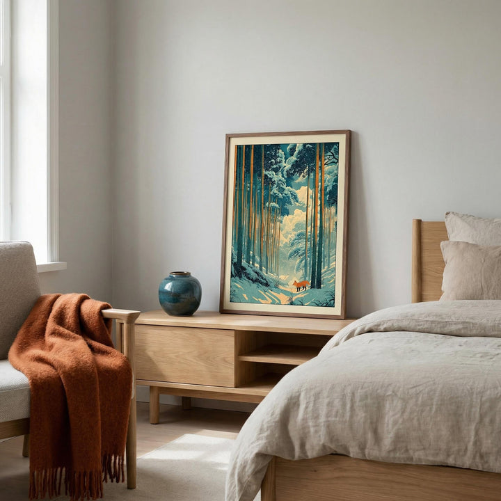Print leaning on a shelf of a red fox in a snowy forest with blue and orange hues in a bedroom