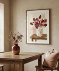 Dining room with wooden table, chair, and framed artwork of a vase with red flowers.