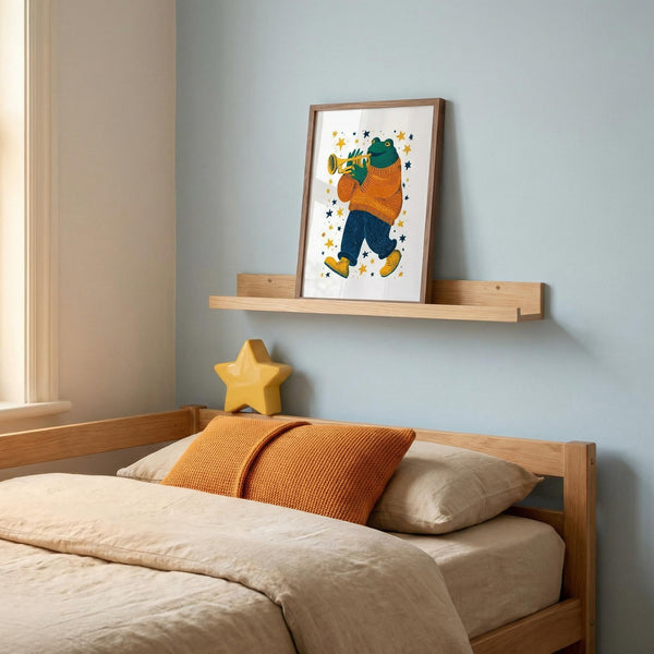 Bedroom with wooden bed, orange pillows, and a framed illustration of a frog playing the trumpet.