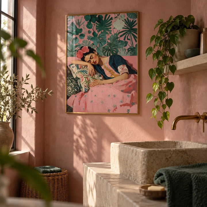 Frida Kahlo Art Prints, framed on the wall of a warm bathroom with pink plaster walls and a plain stone basin