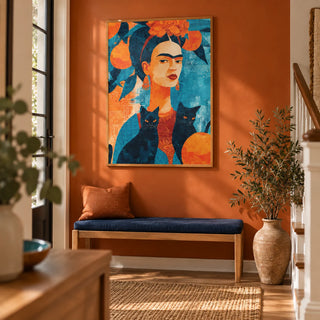 Frida Kahlo Cat, framed on the wall of a warm hallway with a deep orange painted wall