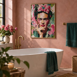 Wall Art Frida Kahlo, framed on the wall of a warm bathroom with a dusty pink limewash wall and a white freestanding bath