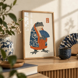 Frog In Kimono Print, a small A4 framed print leaning on an oak shelf in a living room