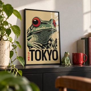 Frog Poster, a small A4 framed print leaning on a black shelf in a living room