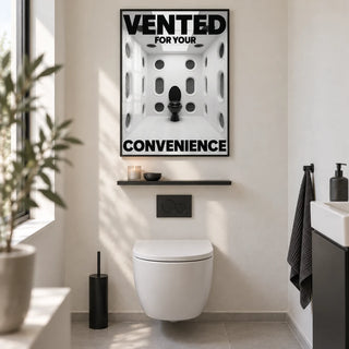 Funny Toilet Sign, framed on the wall of a design-led guest WC with a plain warm white wall and a pale grey floor