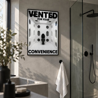Funny Toilet Sign, framed on the wall of a modern shower room with plain grey microcement walls