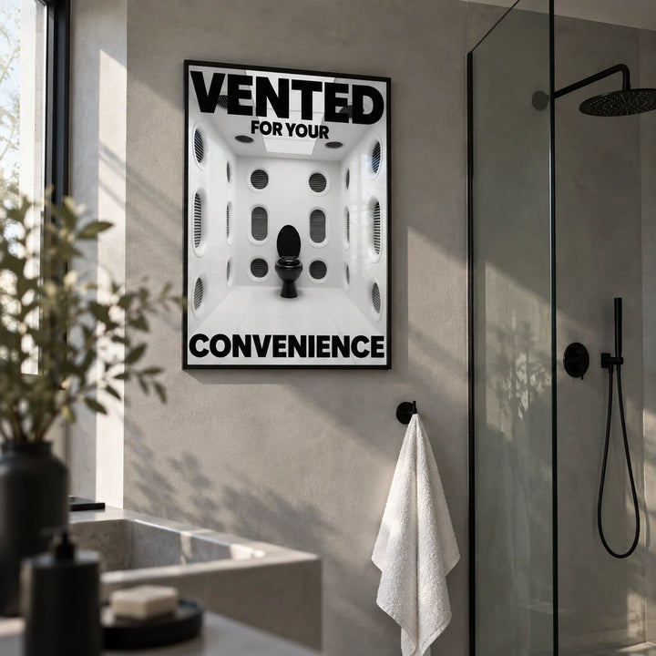 Funny Toilet Sign, framed on the wall of a modern shower room with plain grey microcement walls