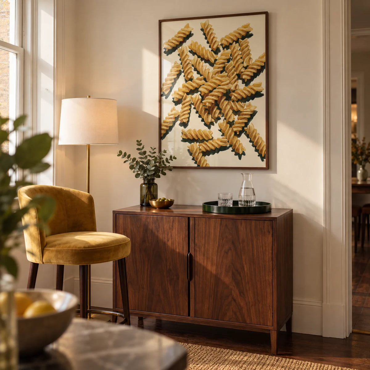 Fusilli Pasta Art, framed on the wall of a compact home bar corner in a UK townhouse with cream walls and a freestanding walnut drinks cabinet in a living room
