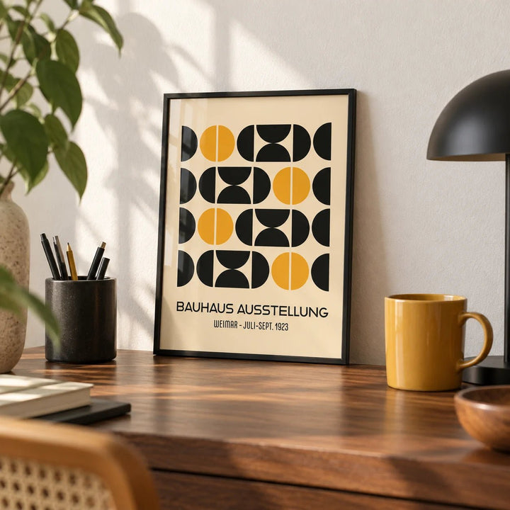 Geometric Bauhaus Poster, a small A4 framed print leaning on a walnut desk