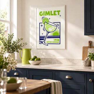 Gimlet Cocktail Poster, framed on the wall of a bright modern kitchen in a UK terraced house with plain navy cabinets and a warm white wall