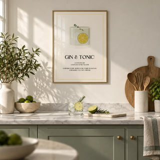 Gin and Tonic Wall Art, framed on the wall of an elegant kitchen with plain sage green cabinets and a pale marble worktop