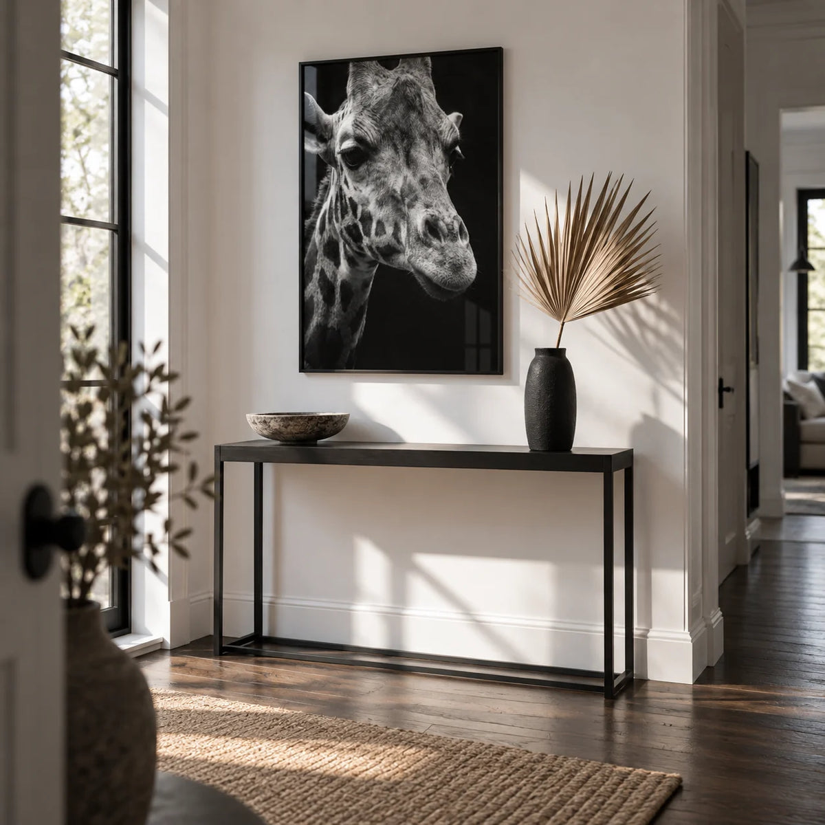 Giraffe Photography Poster, framed on the wall of a crisp white hallway with dark oak floorboards