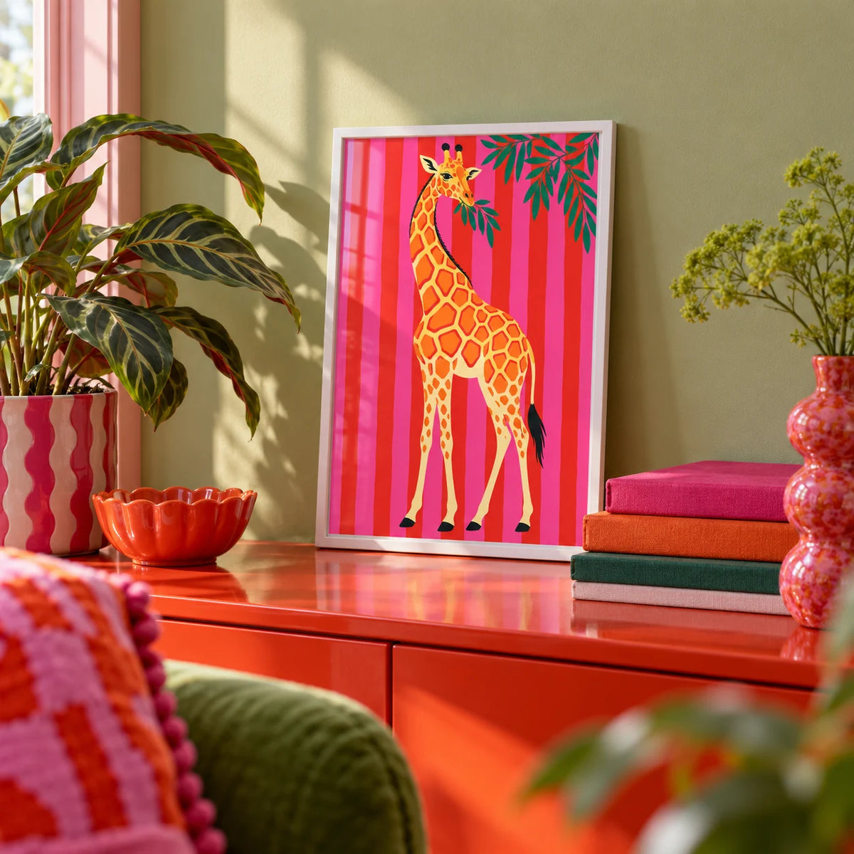 Giraffe Wall Art, a small A4 framed print leaning on a colourful lacquered shelf in a living room