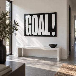 Goal Poster, framed on the wall of a modern hallway with a white wall and a grey floor