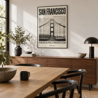 Golden Gate Bridge Art Print, framed on the wall of a modern dining room with a white wall
