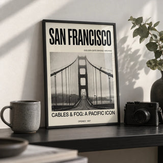 Golden Gate Bridge Art Print, a small A4 framed print leaning on a black shelf in a living room