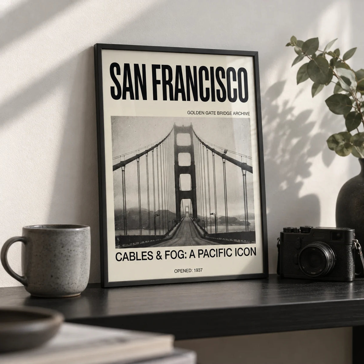 Golden Gate Bridge Art Print, a small A4 framed print leaning on a black shelf in a living room