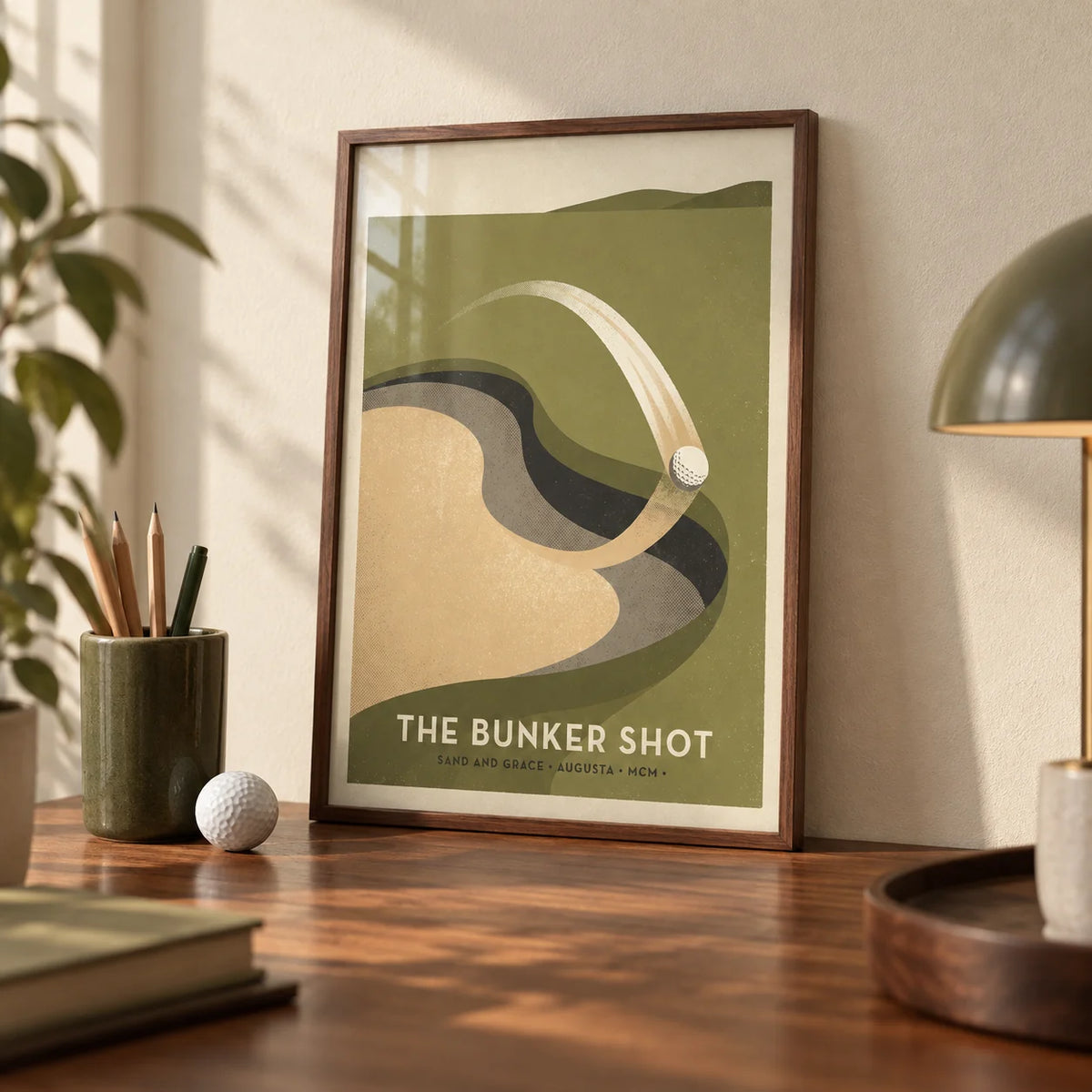 Golf Bunker Art Print, a small A4 framed print leaning on a walnut desk