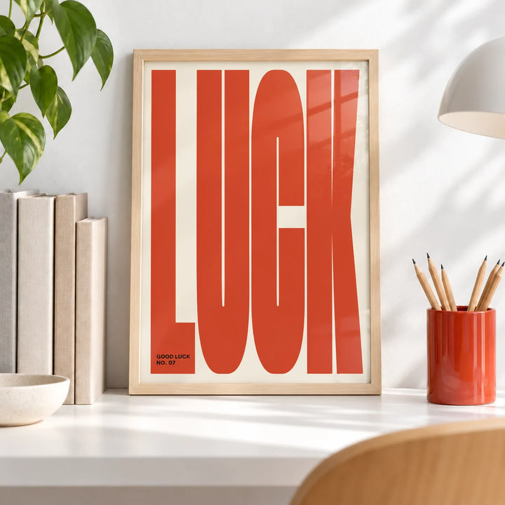 Good Luck Print, a small A4 framed print leaning on a white desk