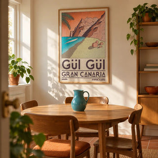 Gran Canaria Beach Art Print, framed on the wall of a compact mid-century dining room in a UK maisonette with warm cream walls and a terracotta floor