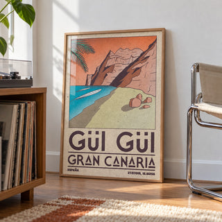 Gran Canaria Beach Art Print shown in a living room, leaning on the floor by a chrome chair (frame not included)