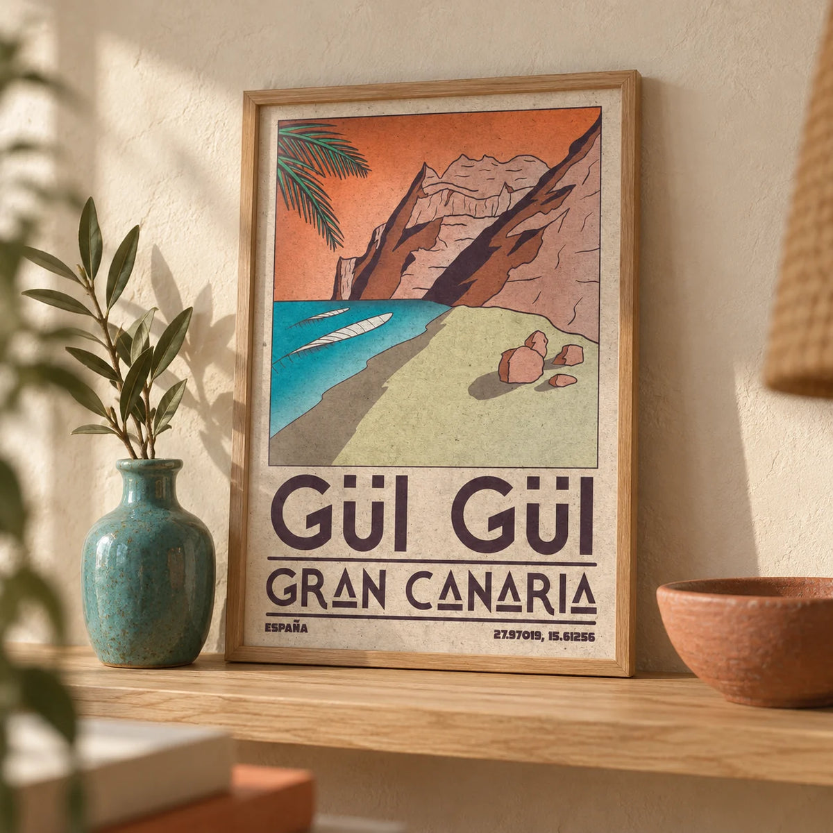 Gran Canaria Beach Art Print, a small A4 framed print leaning on a pale oak shelf in a living room