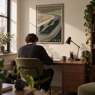 Grand Prix Racing Print, framed on the wall of a compact home study in a young adult's UK first flat (22-28) with a cream wall and walnut furniture