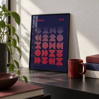 Graphic Design Poster, a small A4 framed print leaning on a black desk