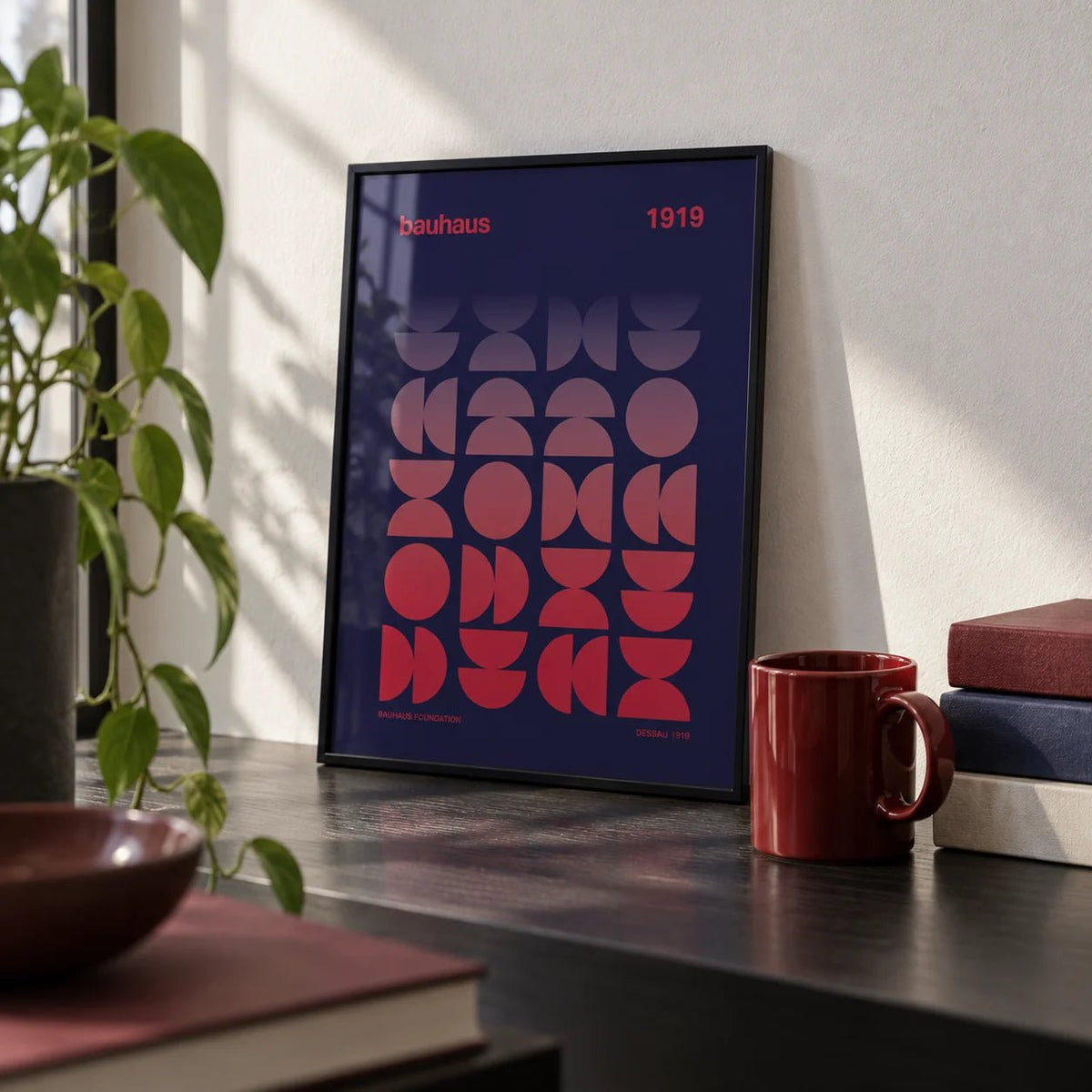 Graphic Design Poster, a small A4 framed print leaning on a black desk