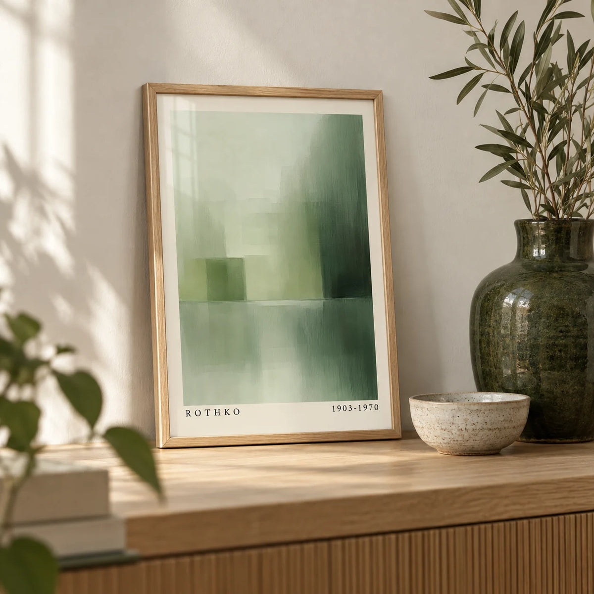Green Abstract Wall Art, a small A4 framed print leaning on a pale oak shelf in a living room
