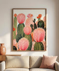 Framed artwork of pink and green cacti on a wall above a sofa.