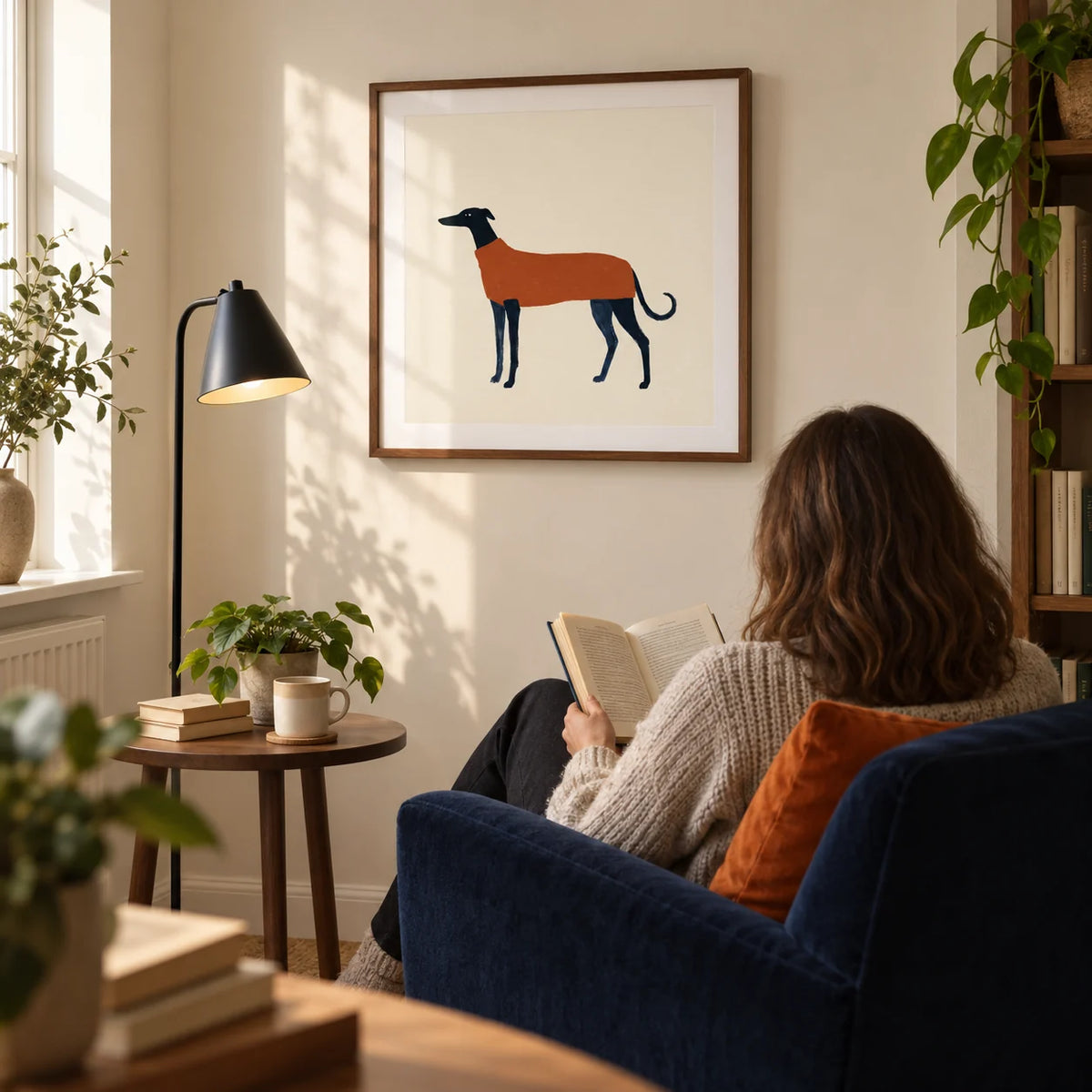 Greyhound Art Print, framed on the wall of a quiet reading corner in a UK flat with a warm cream wall in a living room