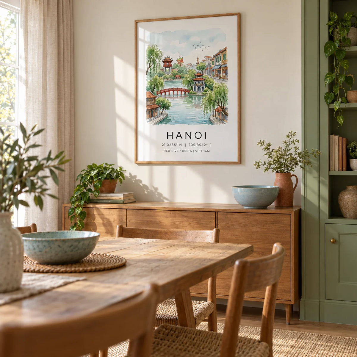 Hanoi Landscape Wall Art, framed on the wall of a relaxed dining room in a UK family home with pale cream walls and a built-in leaf green cupboard