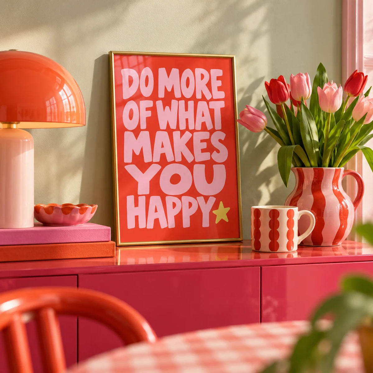Happiness Print, a small A4 framed print leaning on a colourful lacquered shelf in a living room