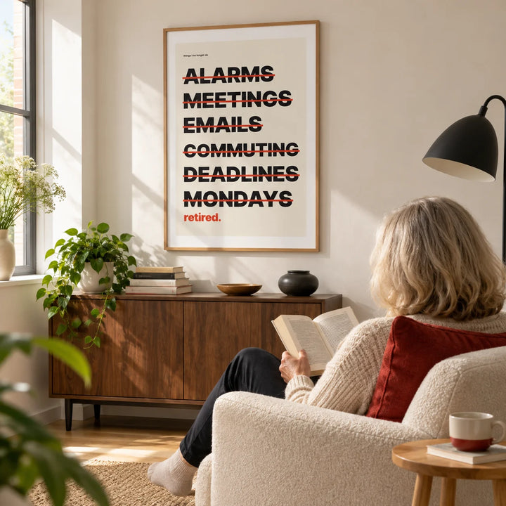 Happy Retirement Poster, framed on the wall of a bright modern reading corner in a UK home with a warm white wall in a living room