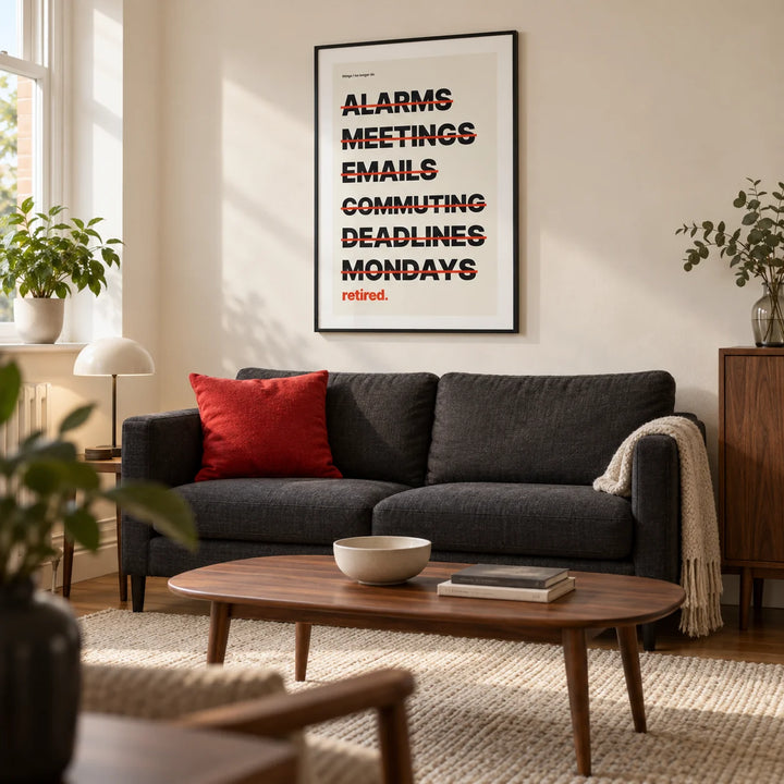 Happy Retirement Poster, framed on the wall of a contemporary living room in a UK downsizer’s flat with a cream wall and walnut furniture