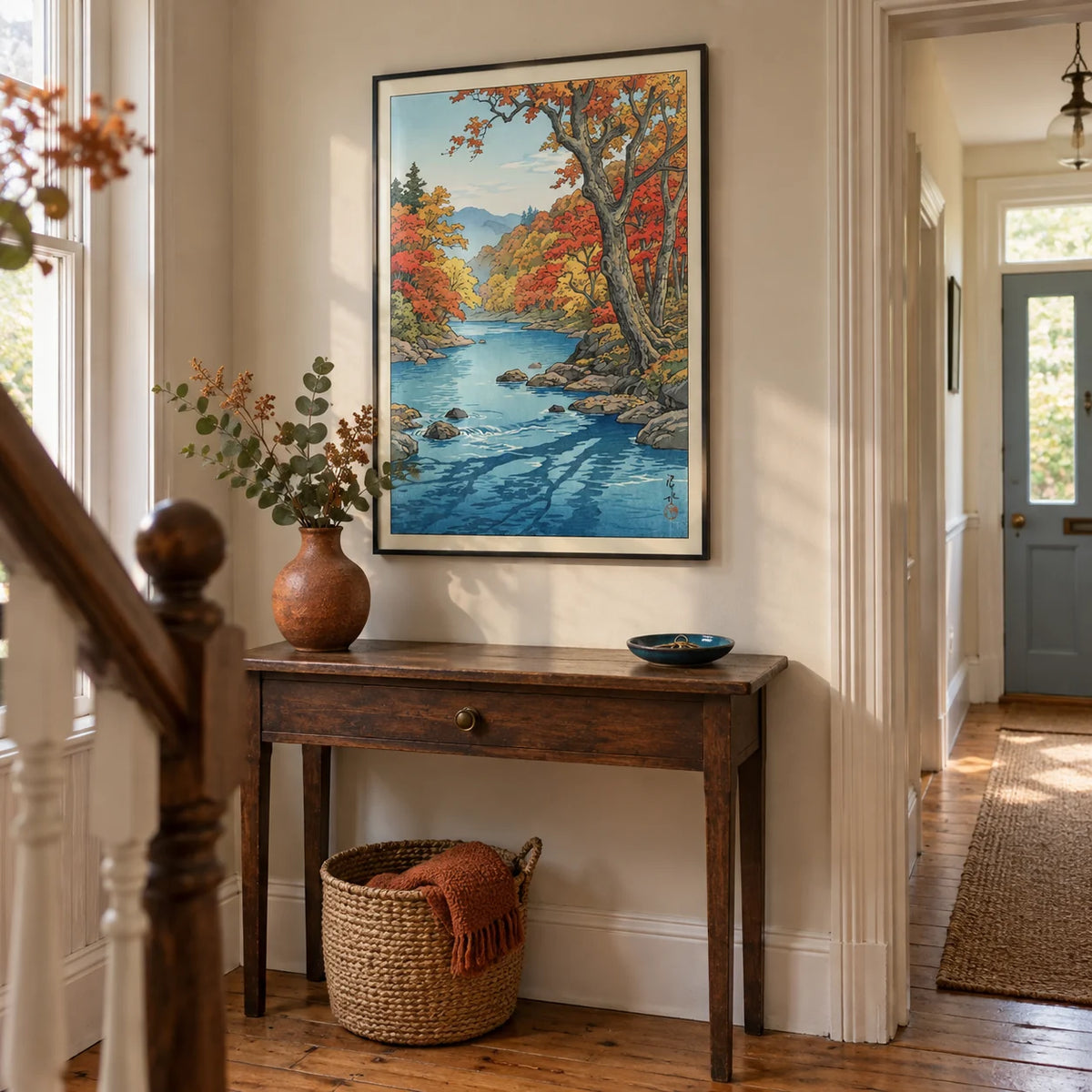 Hasui Kawase Autumn Print, framed on the wall of a welcoming hallway in a compact British terraced house with pale putty walls and restored timber floorboards