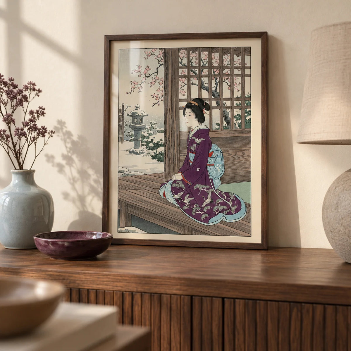 Hasui Kawase Geisha Print, a small A4 framed print leaning on a walnut side table in a hallway