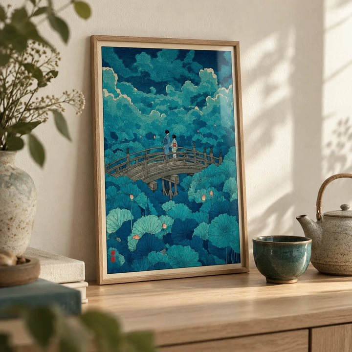 Hasui Kawase Lotus Pond Print, a small A4 framed print leaning on a pale oak shelf in a living room