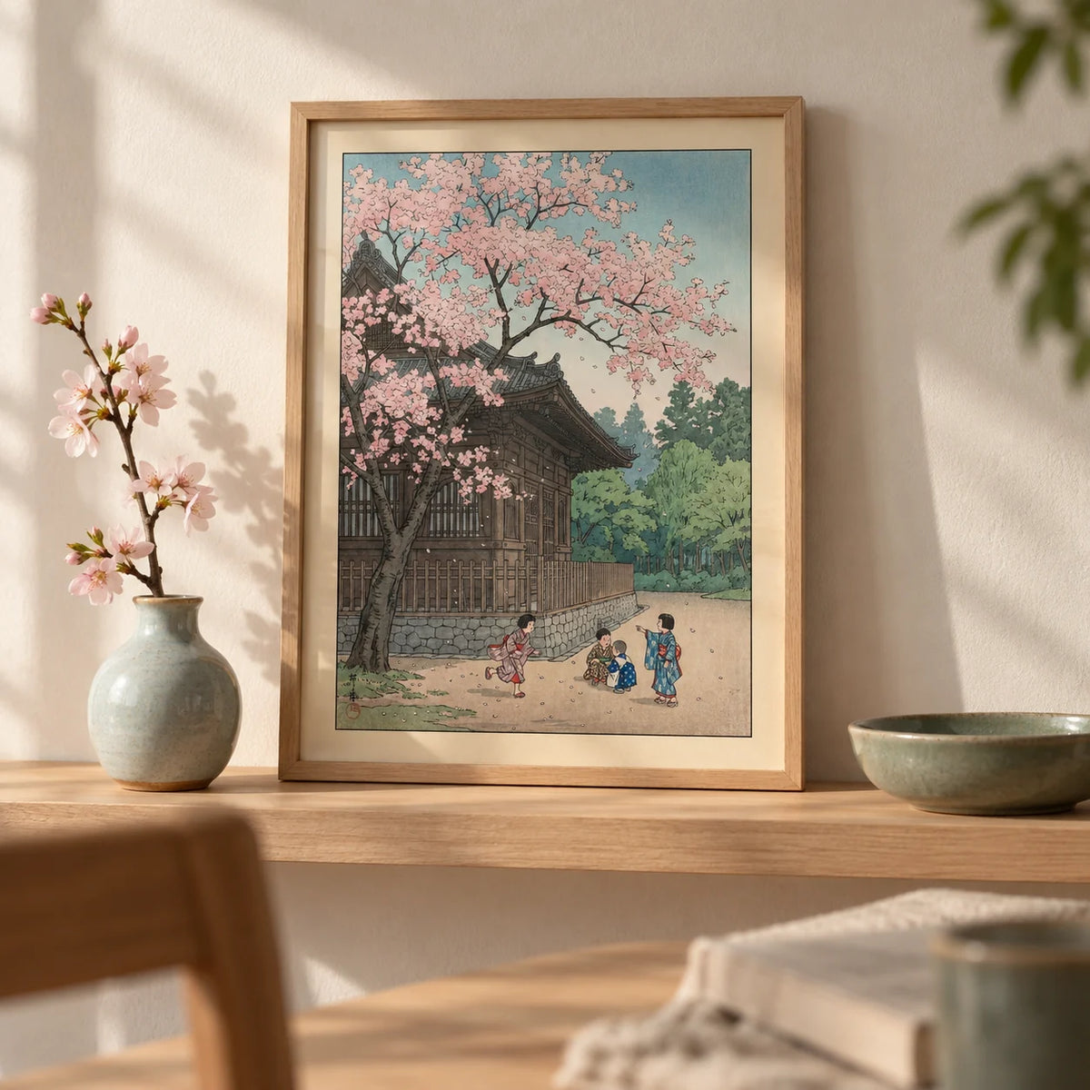 Hasui Kawase Poster, a small A4 framed print leaning on a pale oak shelf in a living room