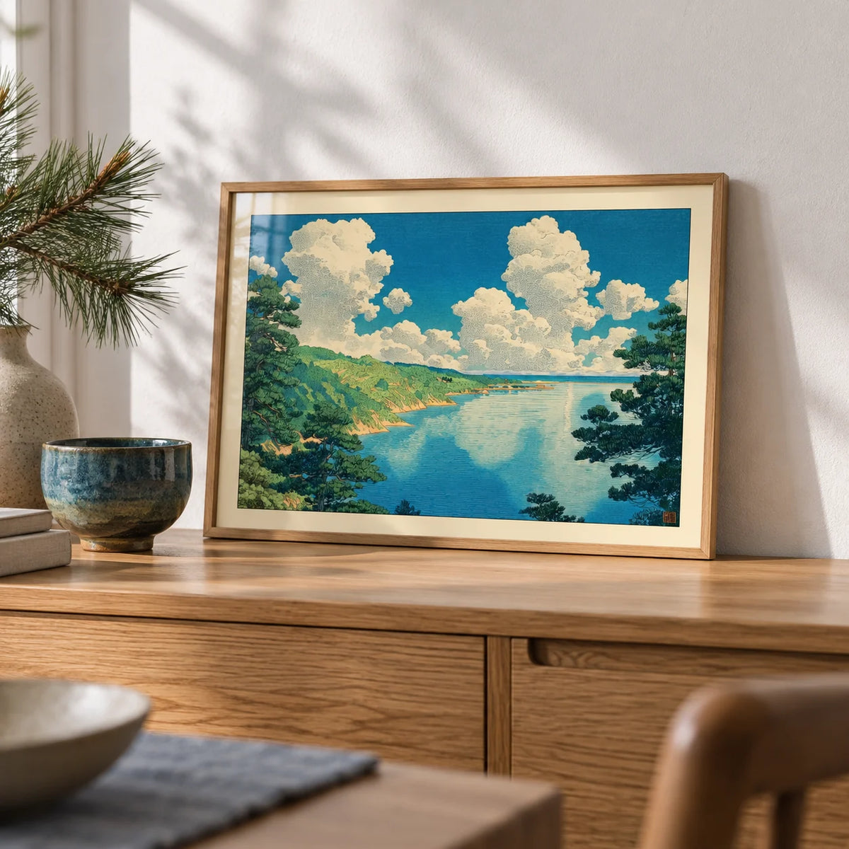 Hasui Kawase Seascape Print, a small A4 framed print leaning on an oak sideboard in a living room