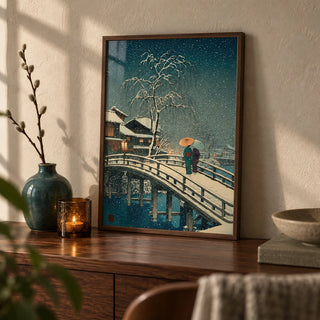 Hasui Kawase Snow Print, a small A4 framed print leaning on a walnut side table in a hallway