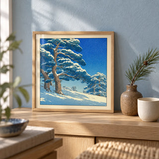 Hasui Kawase Snowy Pines Art Print, a small A4 framed print leaning on a pale oak shelf in a living room