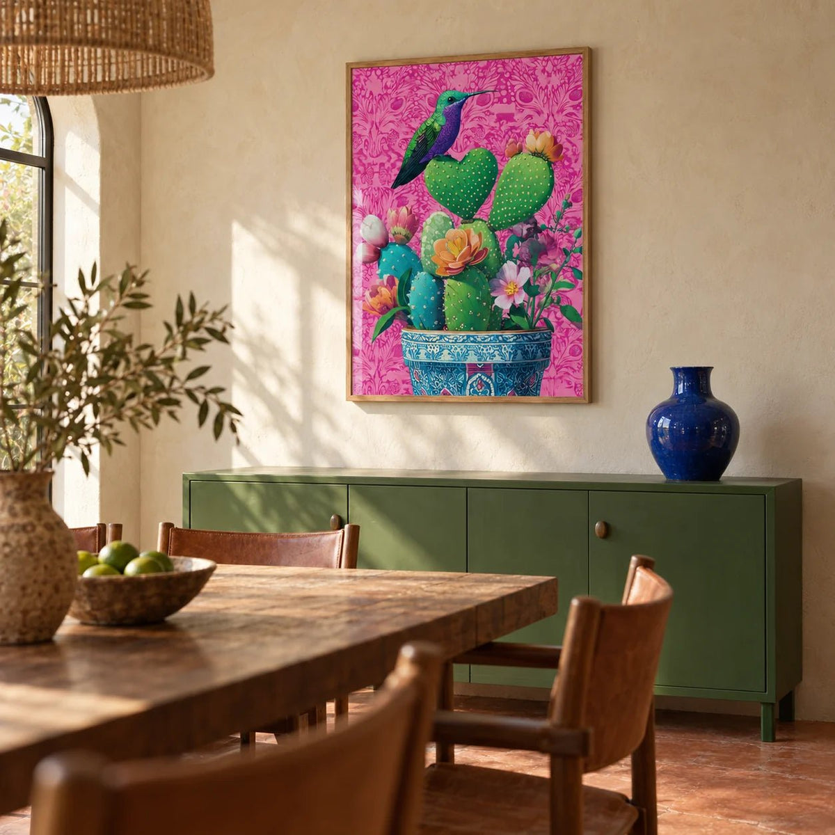 Heart Shaped Cactus, framed on the wall of a Mexican-modern dining room with limewashed walls and a plain terracotta floor